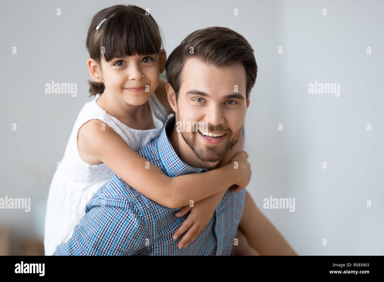 Head shot portrait daughter and father indoors Stock Photo