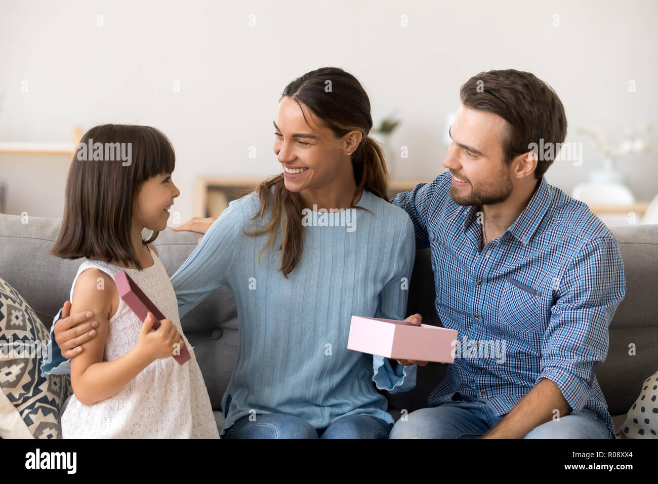 Family celebrate holiday sitting on couch at home Stock Photo