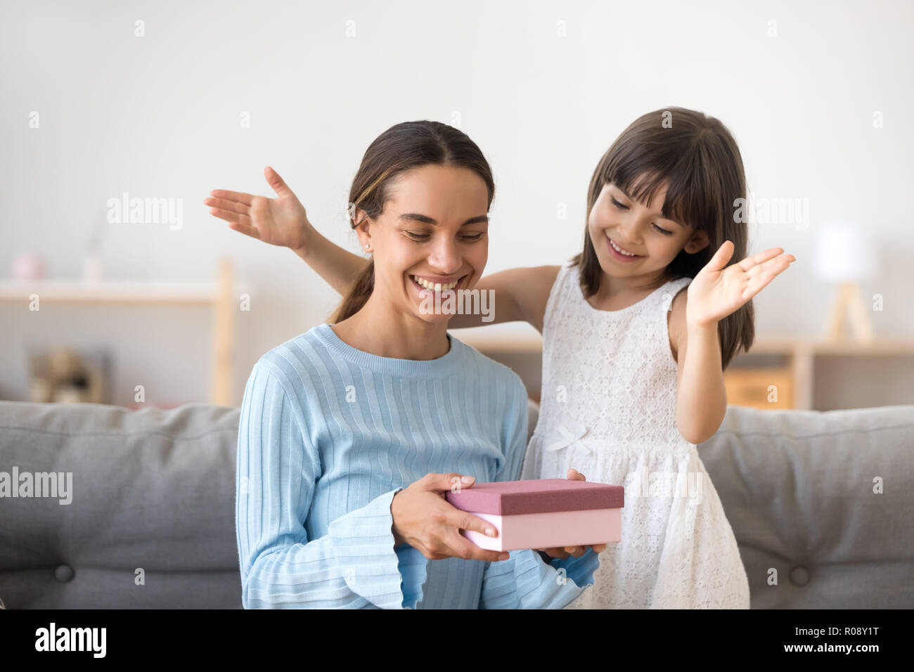 Mother receive from small daughter a gift Stock Photo