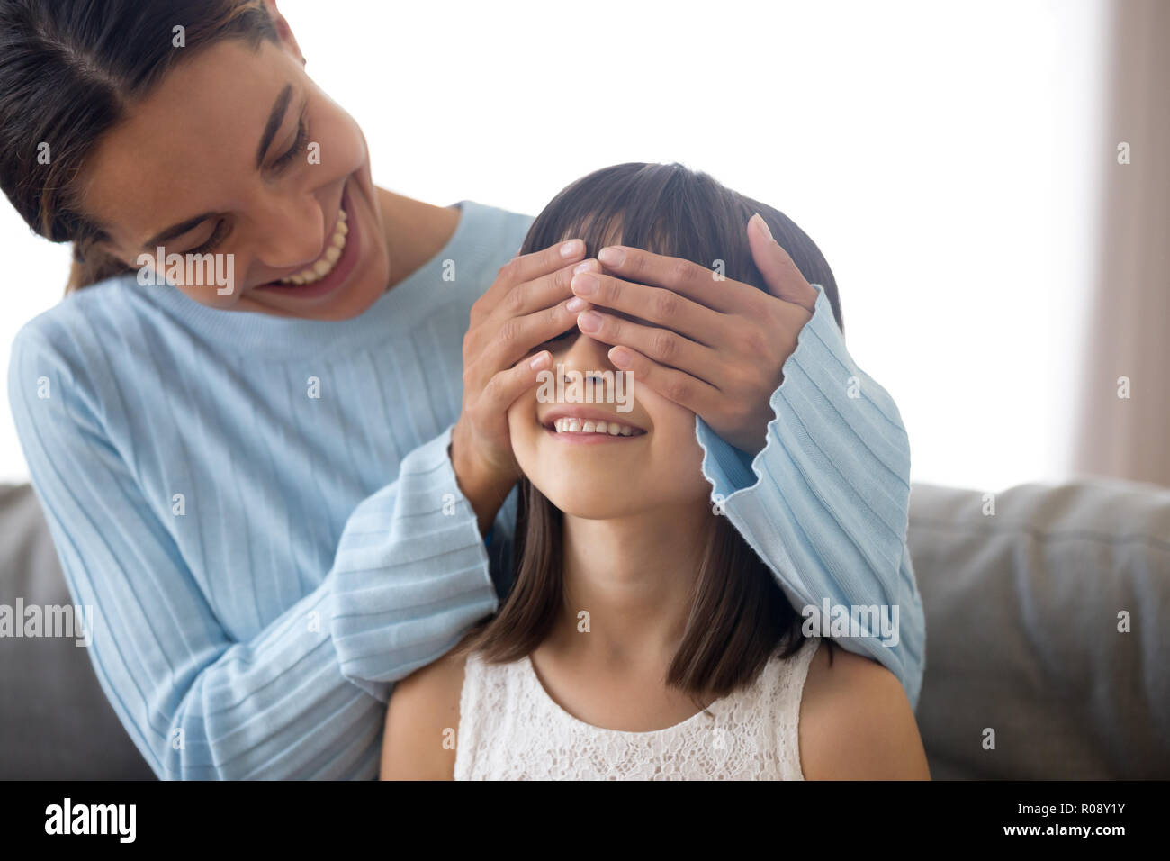 Mother prepare for kid surprise cover her eyes with hands Stock Photo