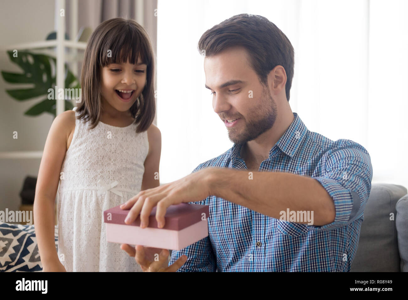 Little daughter prepares for daddy gift at fathers day Stock Photo