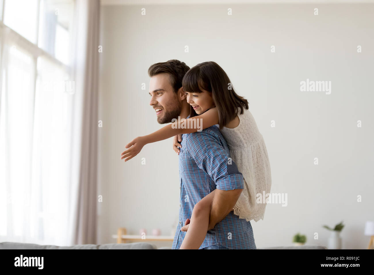 Father playing with beautiful daughter at home Stock Photo