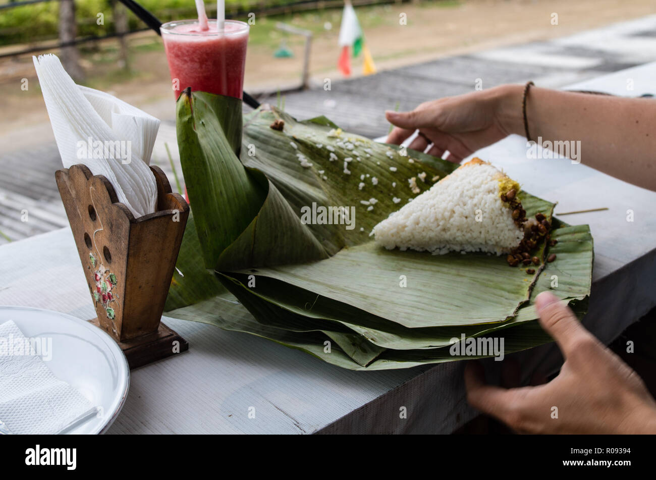 Unpacking NASI PUYUNG dish in Kuta Lombok on table Stock Photo