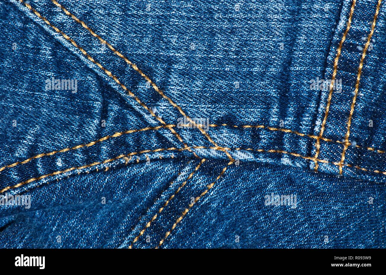 A close up section of a blue denim jacket, showing seams, creases and textures. Stock Photo