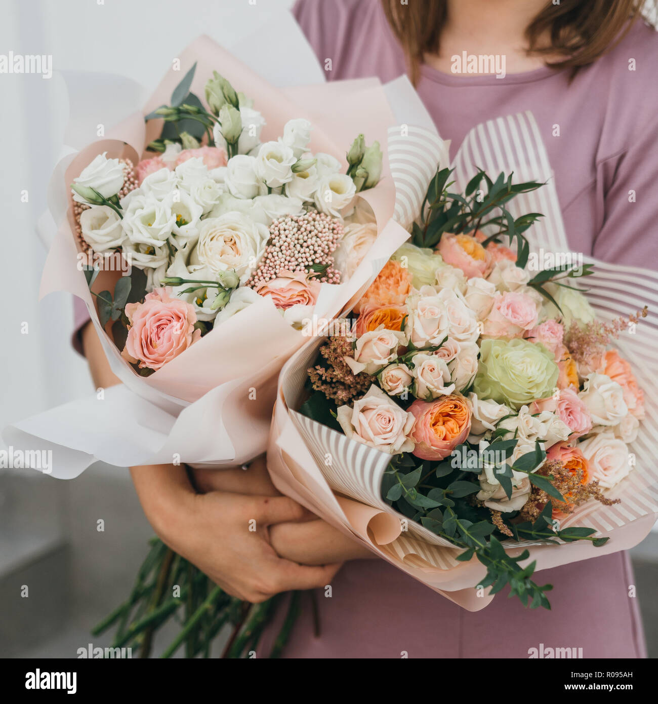 Colorful bouquet of different fresh flowers in the hands of florist