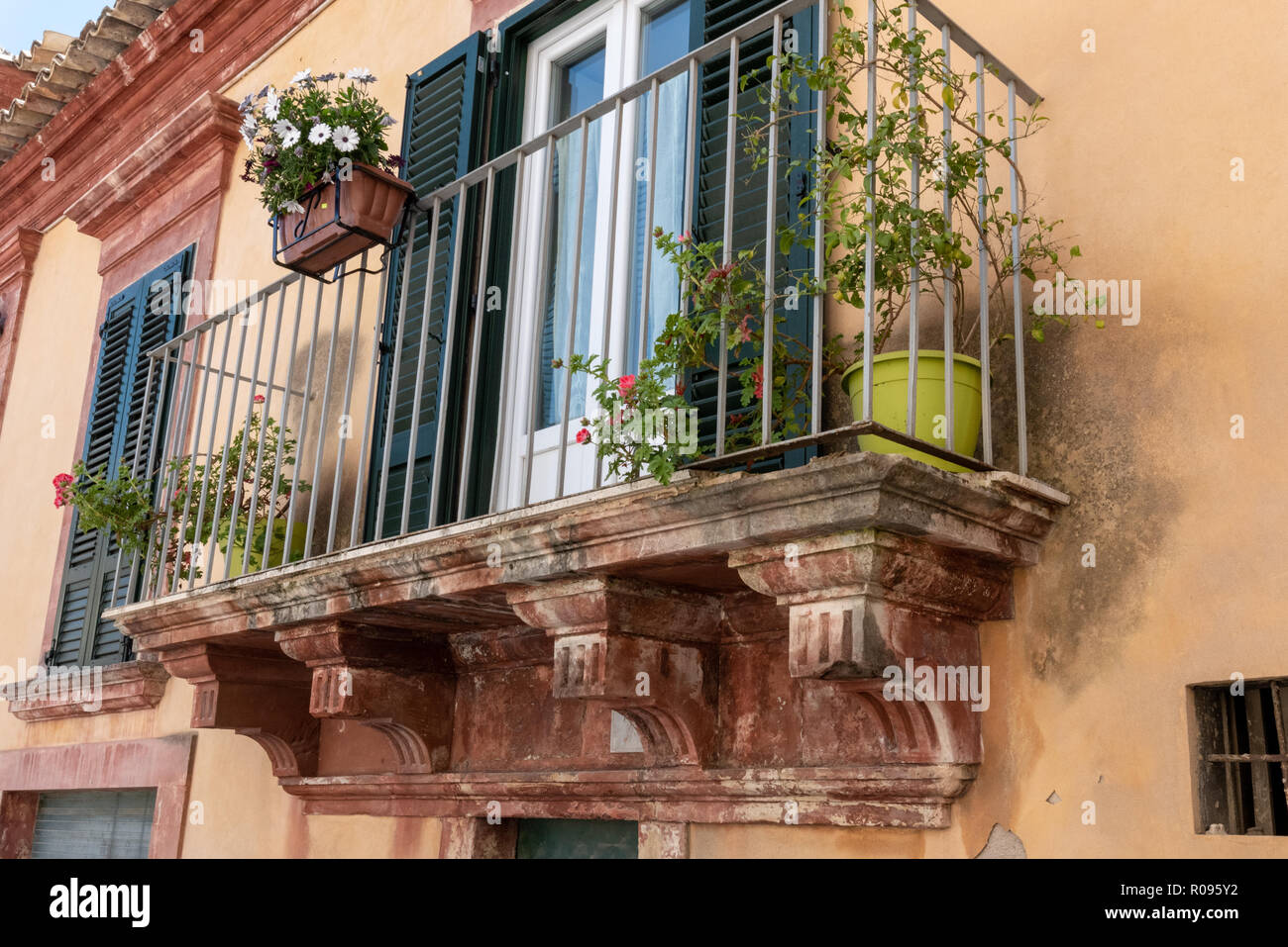 House with Stone Balcony, Green Shutters, Ragusa, Sicily Stock Photo
