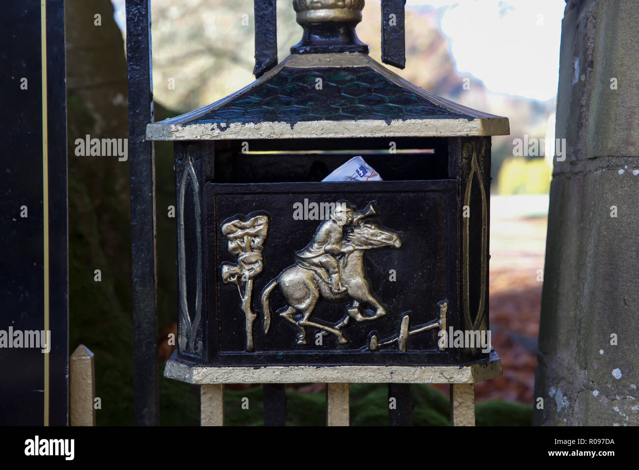 Metal letterbox with horse emblem on the gates to The Hall at AbbeyCwm