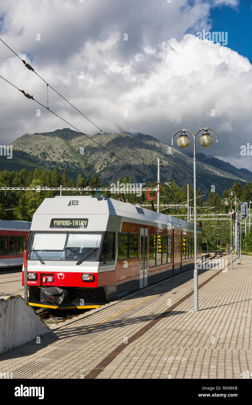 STRBSKE PLESO, SLOVAKIA - JULY 9, 2016: Typical High Tatras train parked in Strbske Pleso terminal train station during cloudy day in summer 2016 Stock Photo