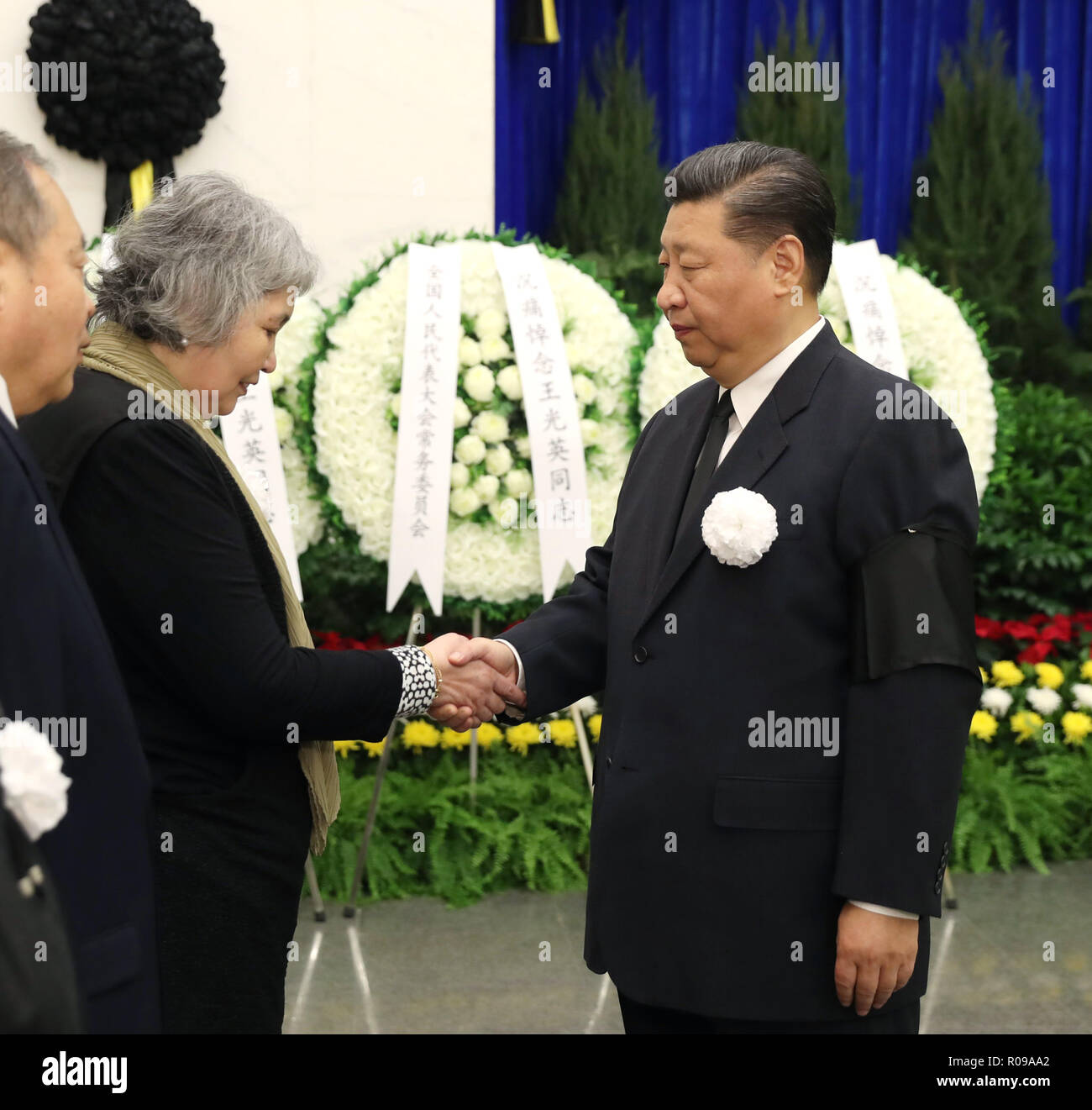 (181102) -- BEIJING, Nov. 2, 2018 (Xinhua) -- Chinese President Xi Jinping (R) shakes hands with a family member of Wang Guangying, a former leader of the China National Democratic Construction Association (CNDCA) and All-China Federation of Industry and Commerce (ACFIC), at the funeral of Wang at the Babaoshan Revolutionary Cemetery in Beijing, capital of China, Nov. 2, 2018. Wang, also former vice chairman of the National People's Congress Standing Committee and former vice chairman of the National Committee of the Chinese People's Political Consultative Conference, passed away due to il Stock Photo