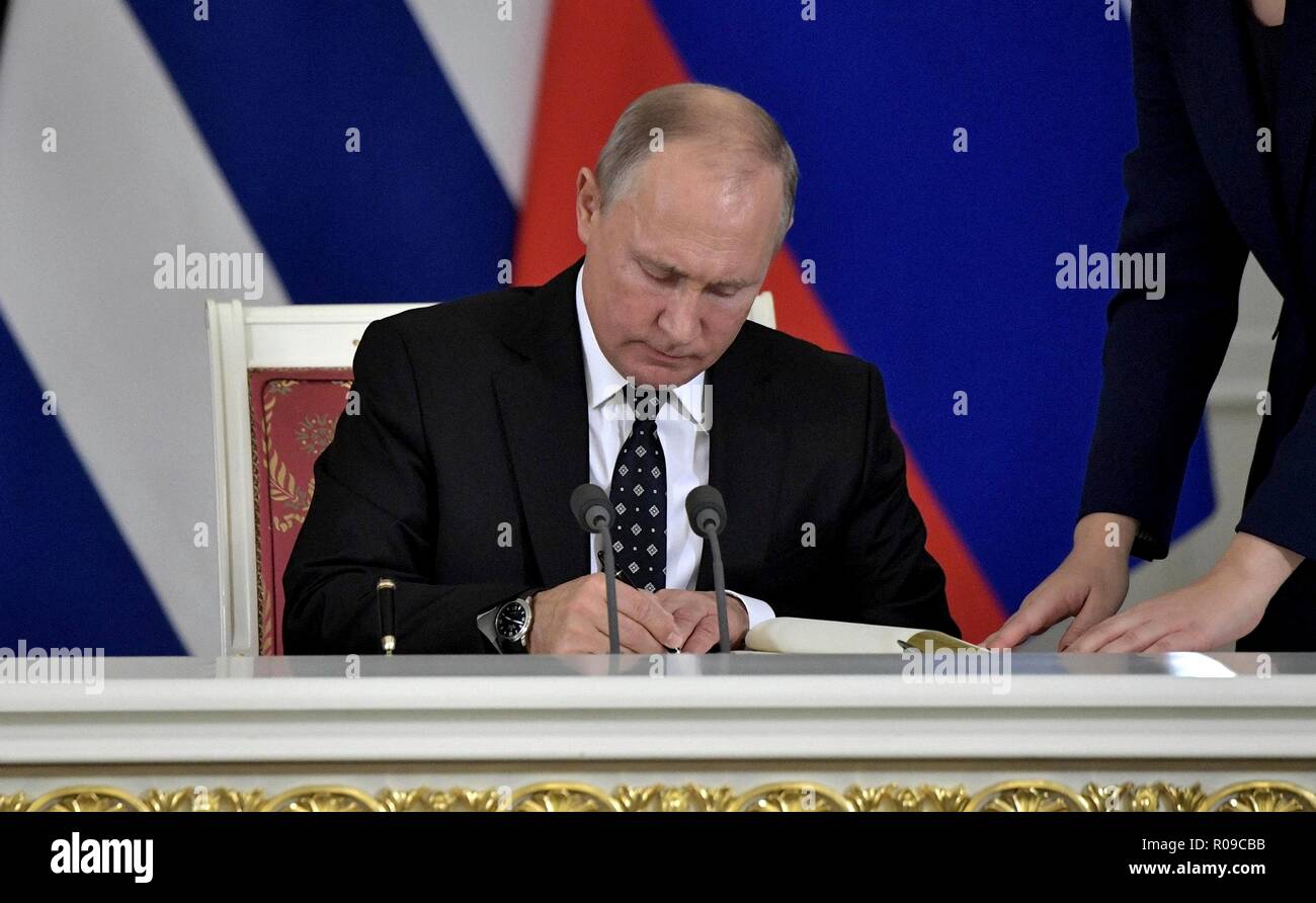 Russian President Vladimir Putin signs an agreement following Russian - Cuban talks during a ceremony at the Kremlin November 2, 2018 in Moscow, Russia. Stock Photo
