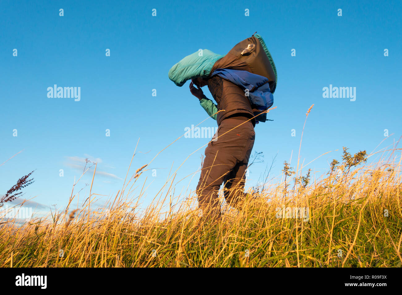 Man walking into a strong wind. UK Stock Photo