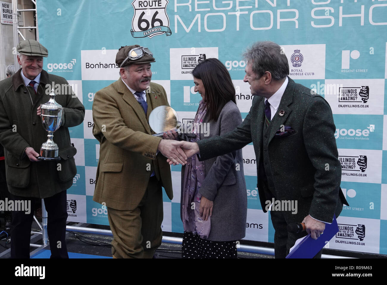 Westminster, London, W1, UK. 3rd Nov, 2018. Harold Pritchard and his wife (1903 De Dion) picks up his trophy for 'Best in Show' at the Concourse d'elegance from Alan Titchmarsh and Luciana Magliocco, Director of the New West End Company at the Illinois Route 66 sponsored, Regent Street Motor Show, Westminster, London, UK Credit: Motofoto/Alamy Live News Stock Photo