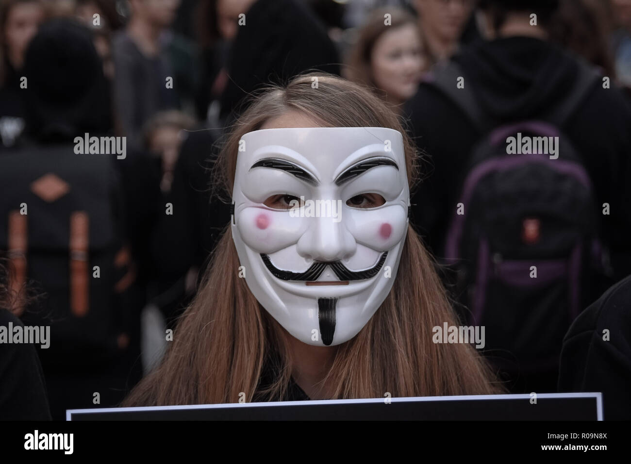 Athens, Greece. 3rd Nov, 2018. A participant seen standing wearing anonymous mask during the protest.Anonymous is a vegan activists group wearing black clothes while holding laptops and placards as they demonstrate against exploitation of animals, The Cube of Truth is a peaceful static demonstration akin to an art performance. Credit: Nikolas Joao Kokovlis/SOPA Images/ZUMA Wire/Alamy Live News Stock Photo