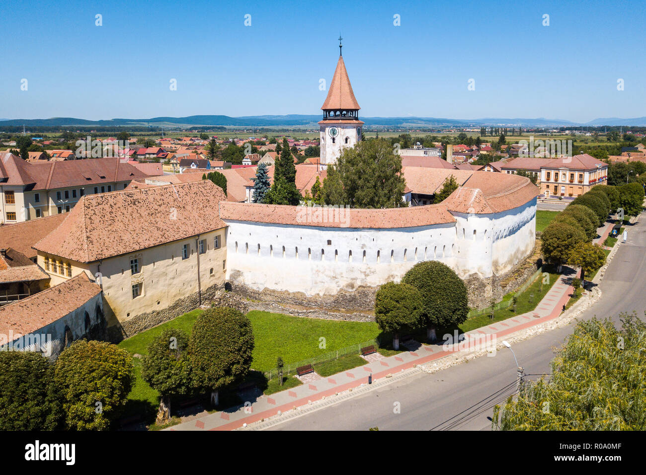 Prejmer Fortified Church, Brasov County, Transylvania, Romania. Aerial view. Medieval fortress with a church, clock tower, high spire, thick walls. Stock Photo