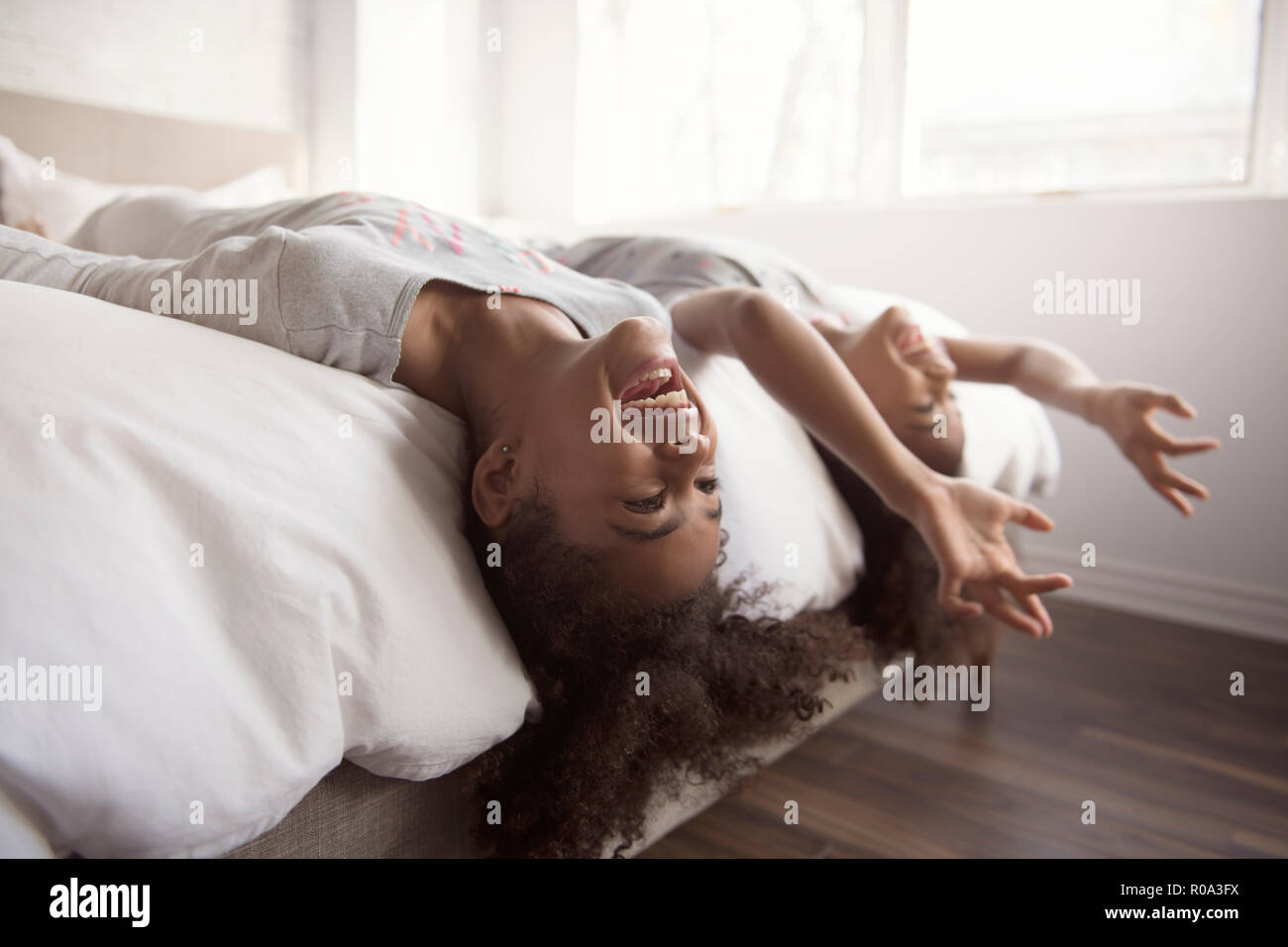 The Two little african american girls on bed at home Stock Photo