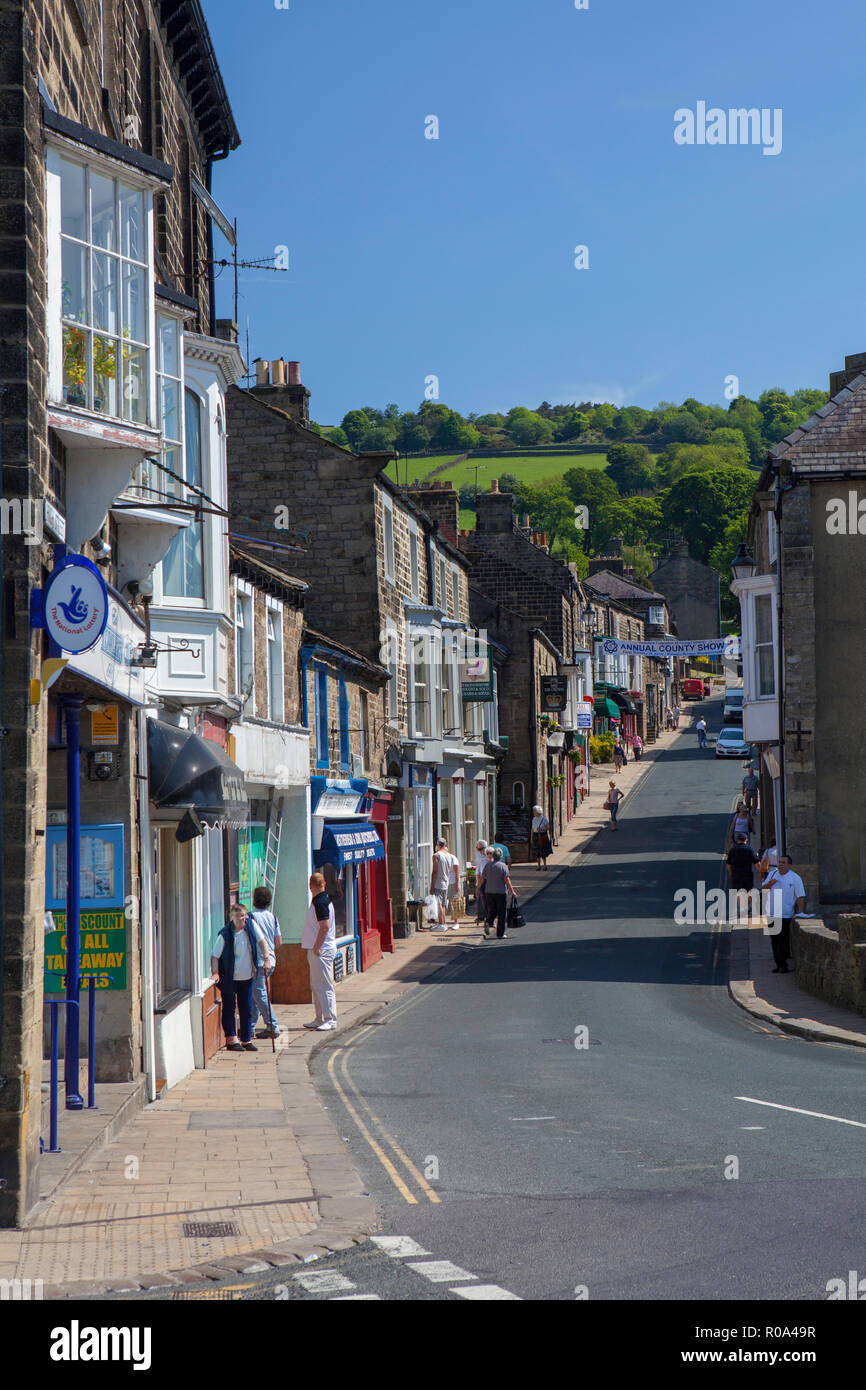 Summer view of Pateley Bridge High Street, with shops Along each side ...