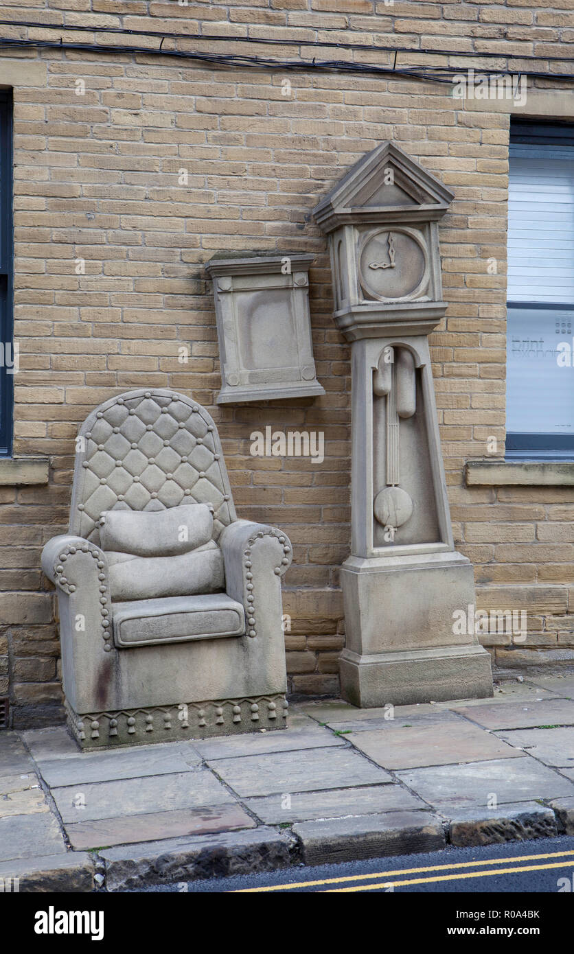 Grandad’s Clock and Chair, a stone sculpture in the Little Germany area of Bradford in West  Yorkshire Stock Photo