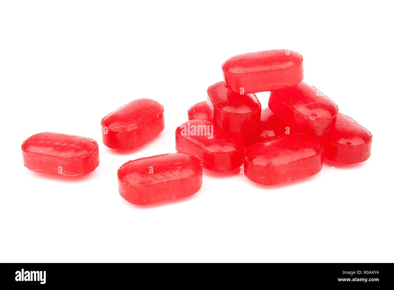 Red Triangle Sweet Red sweet candies on a white background Stock Photo - Alamy