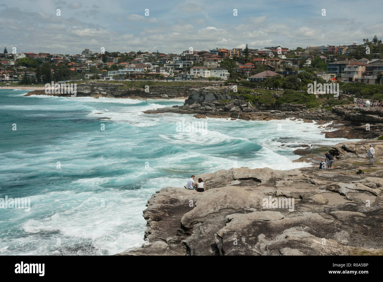 Looking along the coast from the Bondi coastal walk and path with Tamarama and Bronte bays and beaches. Sunny day with high sea surf. Sydney Australia Stock Photo