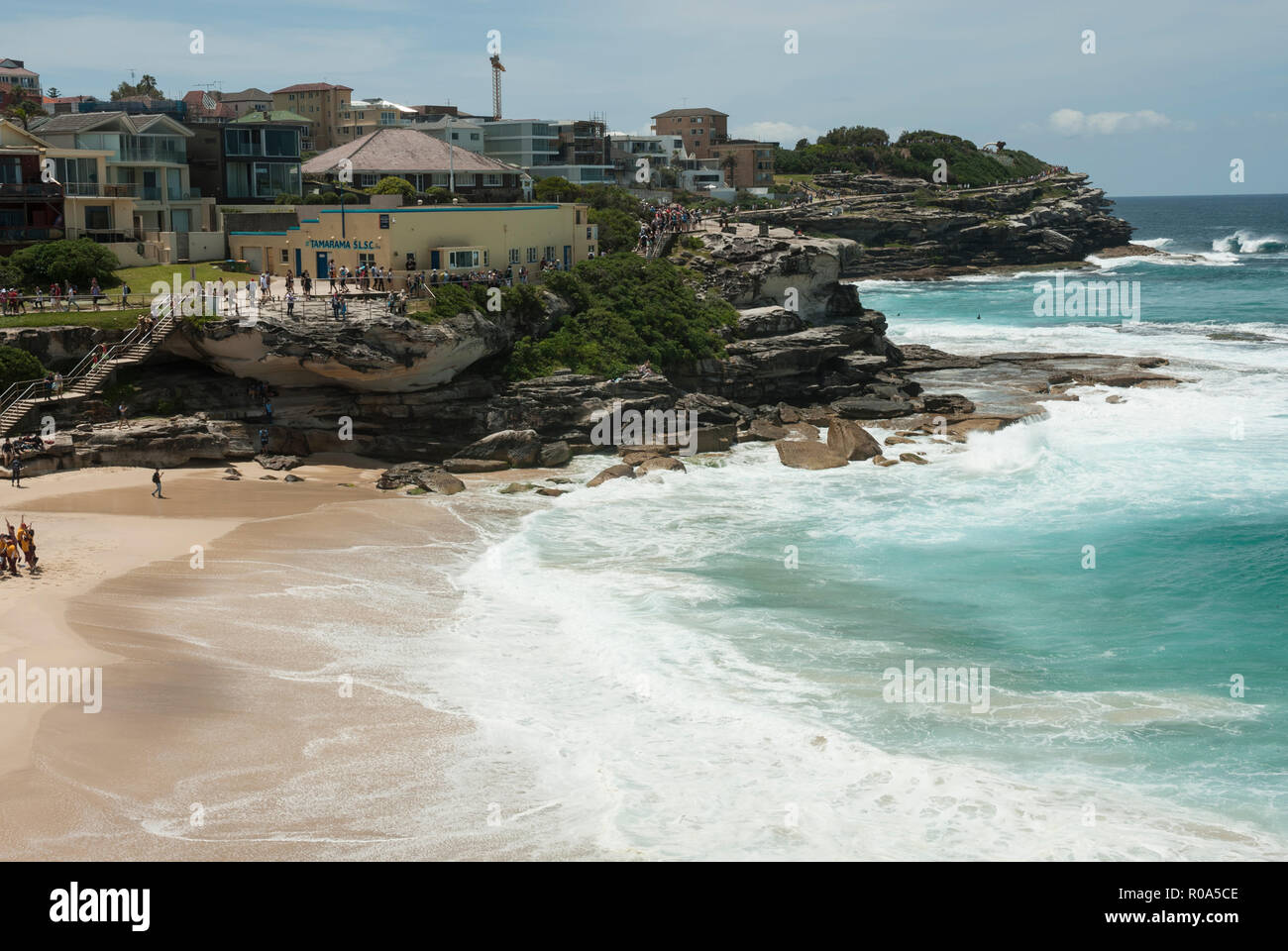 View along Tamarama Beach foreshore from the coastal walk with golden sands, turquoise sea and surf. Sydney Australia. Stock Photo