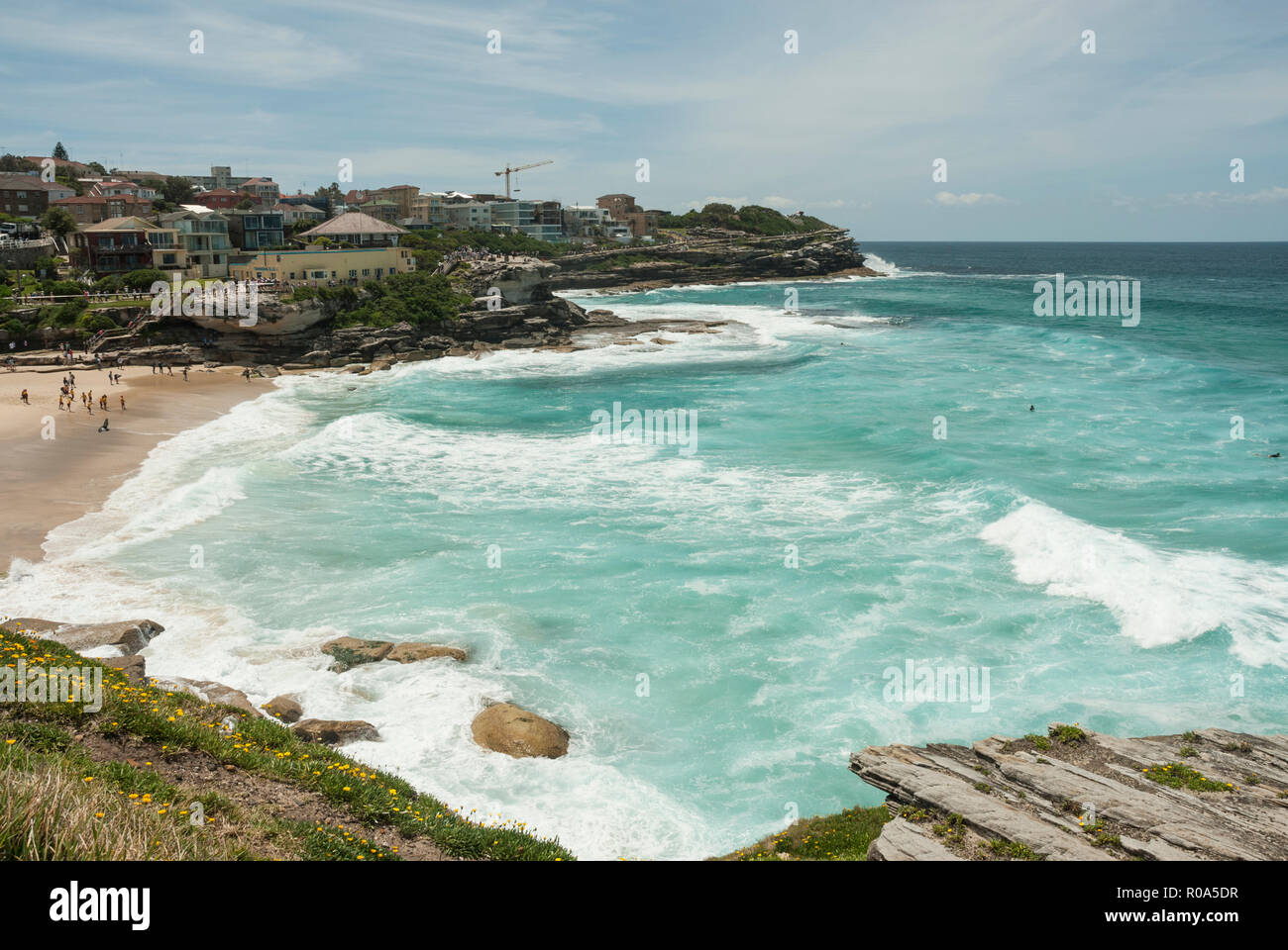 View along Tamarama Beach foreshore from the coastal walk with golden sands, turquoise sea and surf. Sydney Australia. Stock Photo