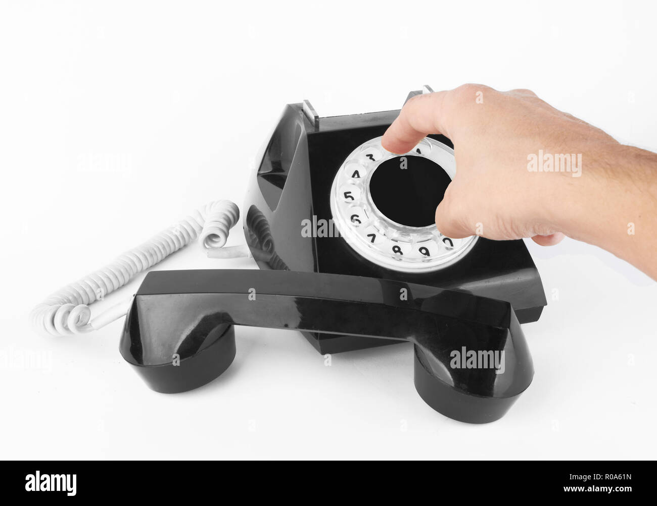 black old phone with hand on white background Stock Photo