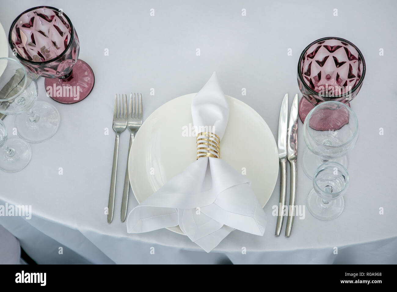 Beautiful table setting with crockery for a party, wedding reception or  other festive event. Glassware and cutlery for catered event dinner.  Horizonta Stock Photo - Alamy