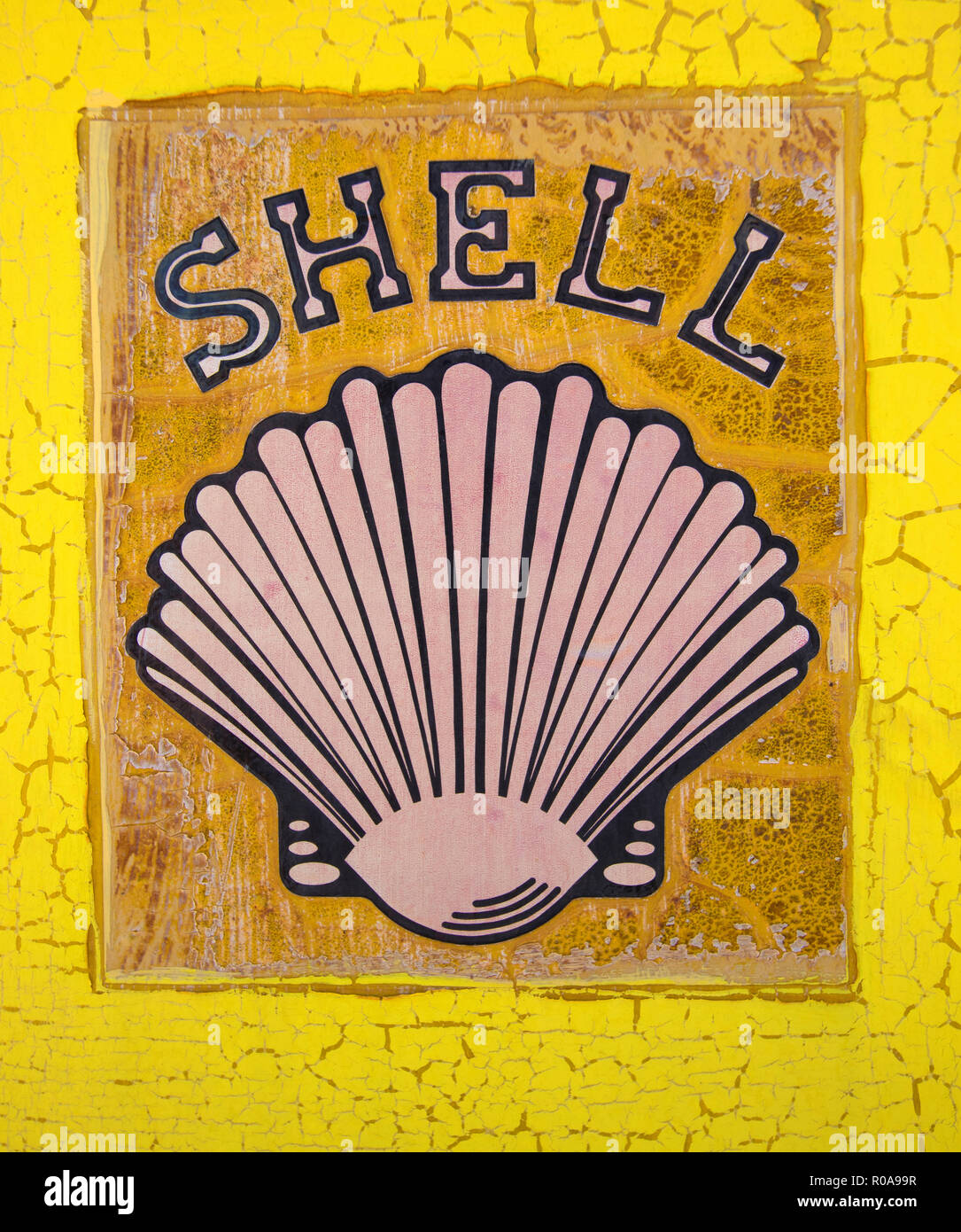 Vintage Shell Oil Company logo on the side of an old yellow petrol bowser pump Stock Photo
