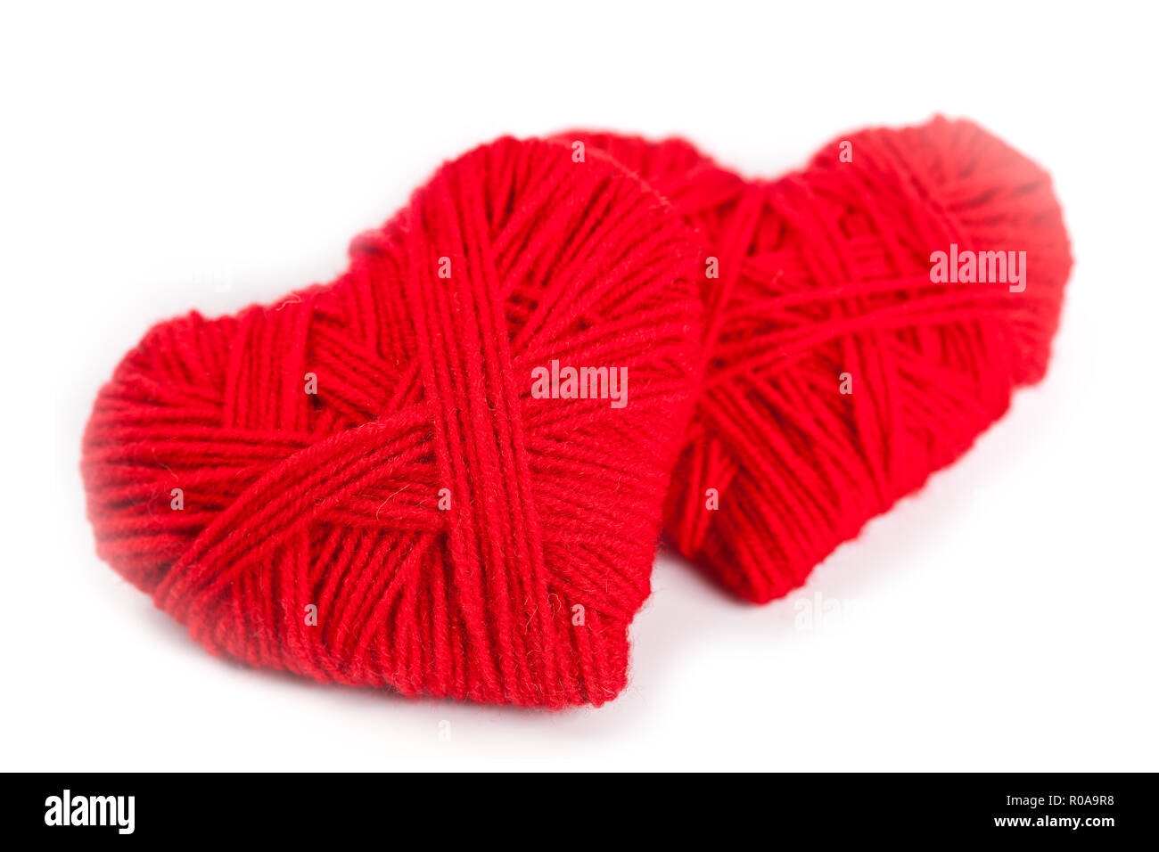 two red thread hearts isolated on white background Stock Photo - Alamy