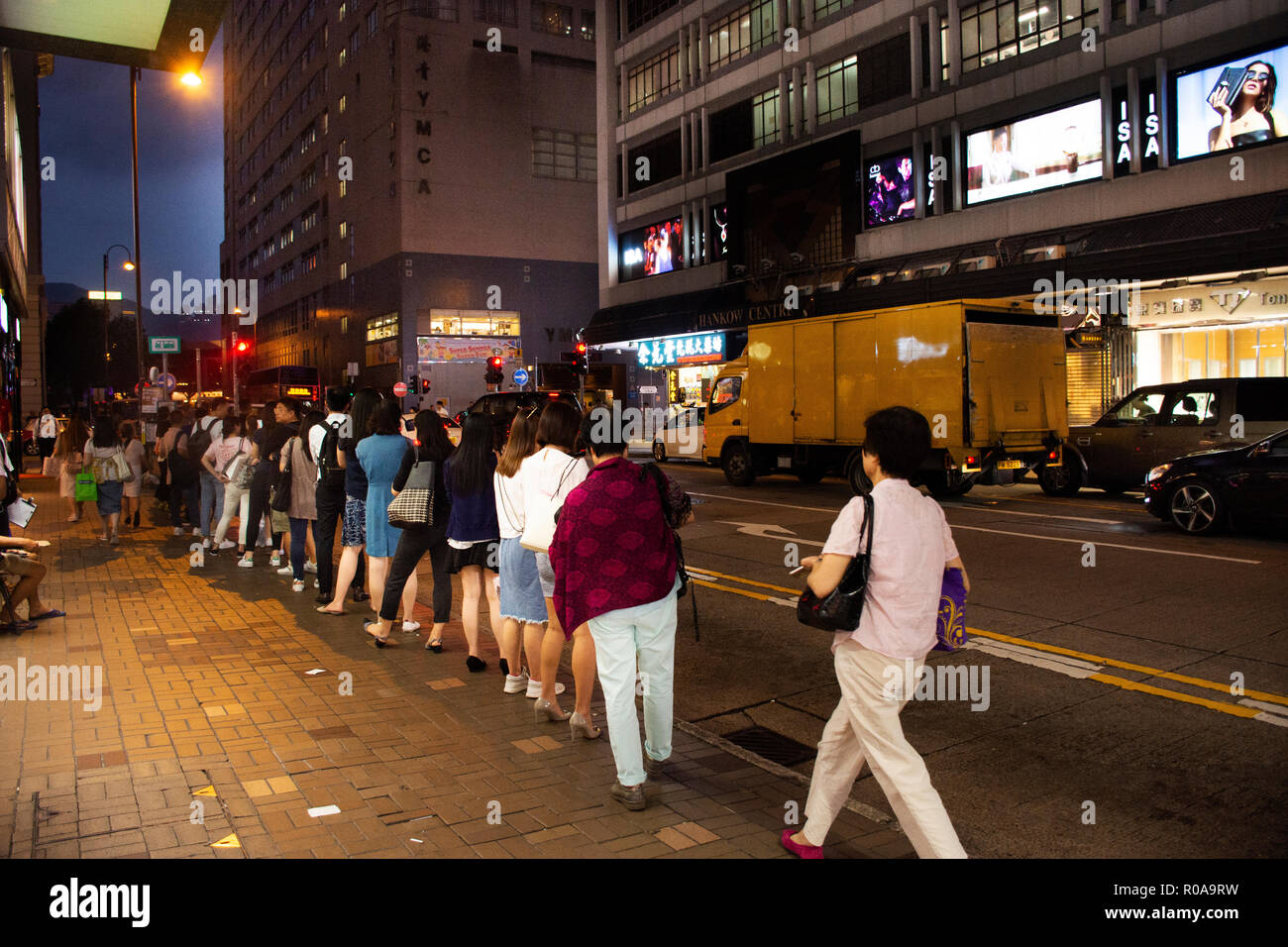 Chinese people standing in queue line for wait bus at station for go home after finish work at Tsim Sha Tsui town in evening on September 5, 2018 in H Stock Photo