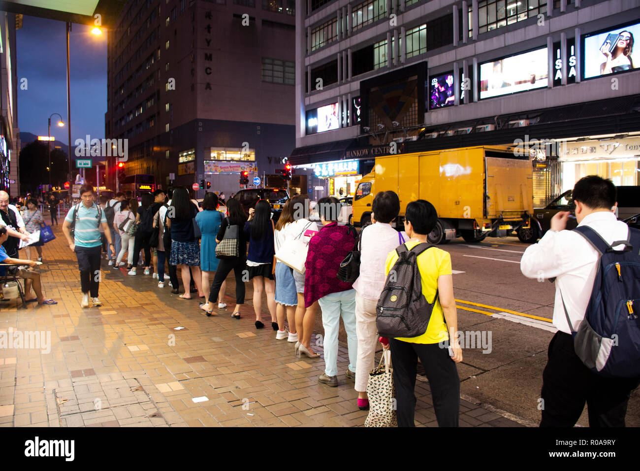 Chinese people standing in queue line for wait bus at station for go home after finish work at Tsim Sha Tsui town in evening on September 5, 2018 in H Stock Photo