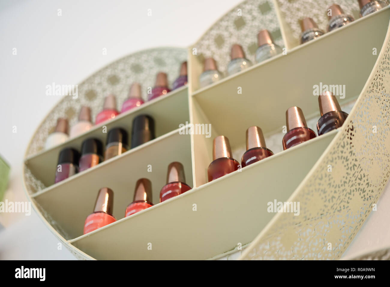 Bookcase with nail polish with heart shape in cosmetic section in store Stock Photo