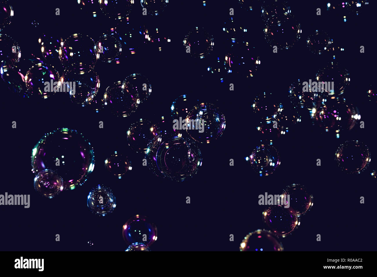 soap bubbles floating on a black background Stock Photo - Alamy