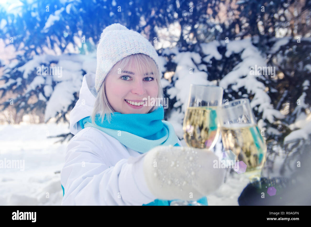 Beautiful attractive blonde clinks a glass of champagne in her hands celebrates the New Year Stock Photo