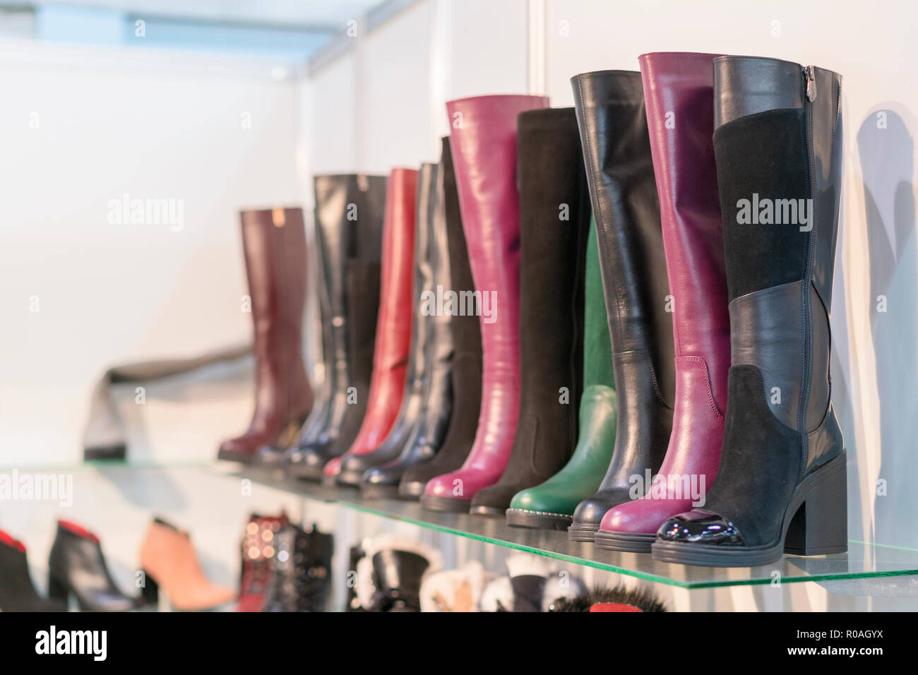 women's boots on the shelves in the store. Pavilion of the store with ...