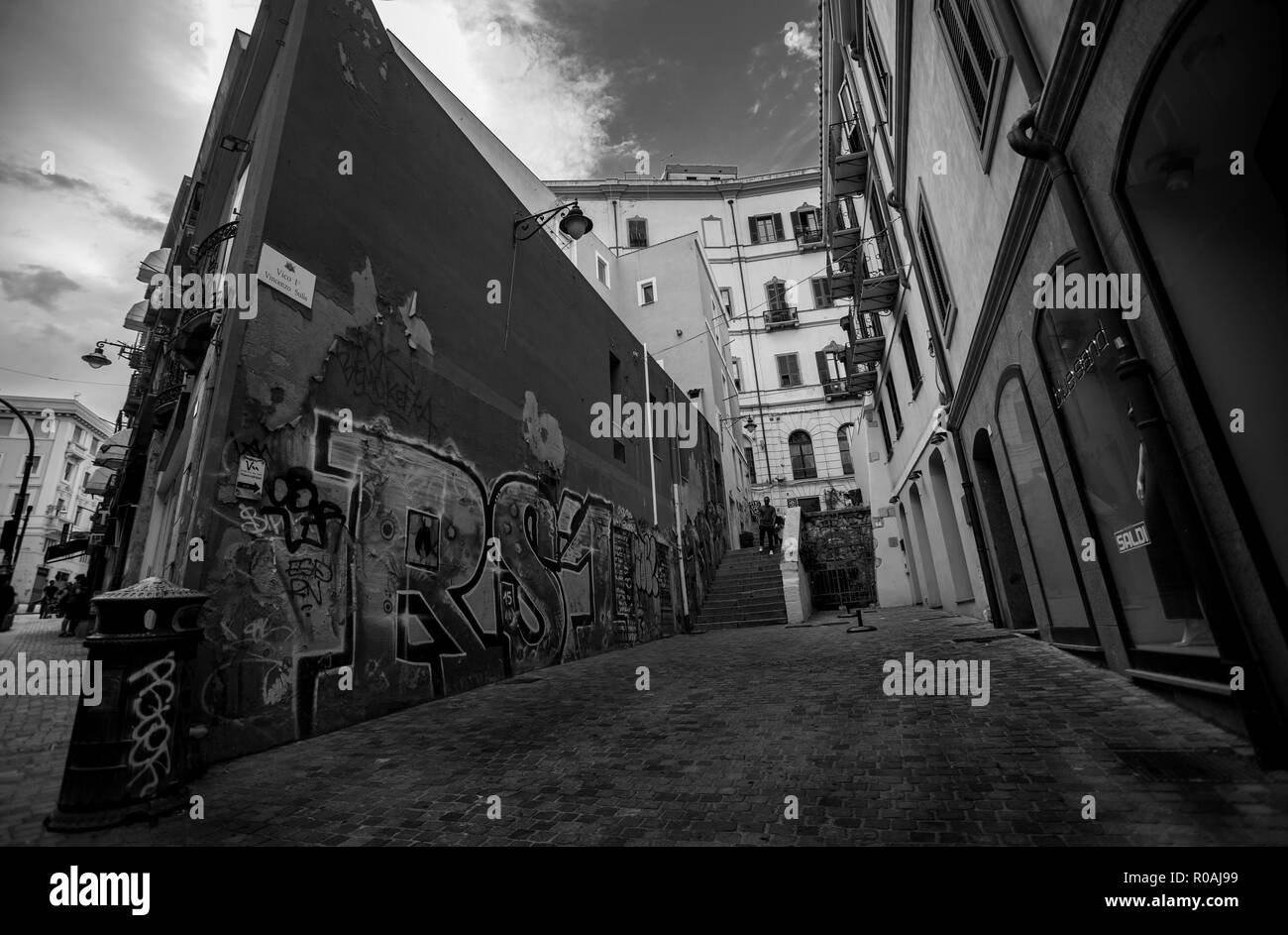 Small alley of Cagliari in Sardinia with a wall covered with Graffiti: Picture in black and white. Stock Photo