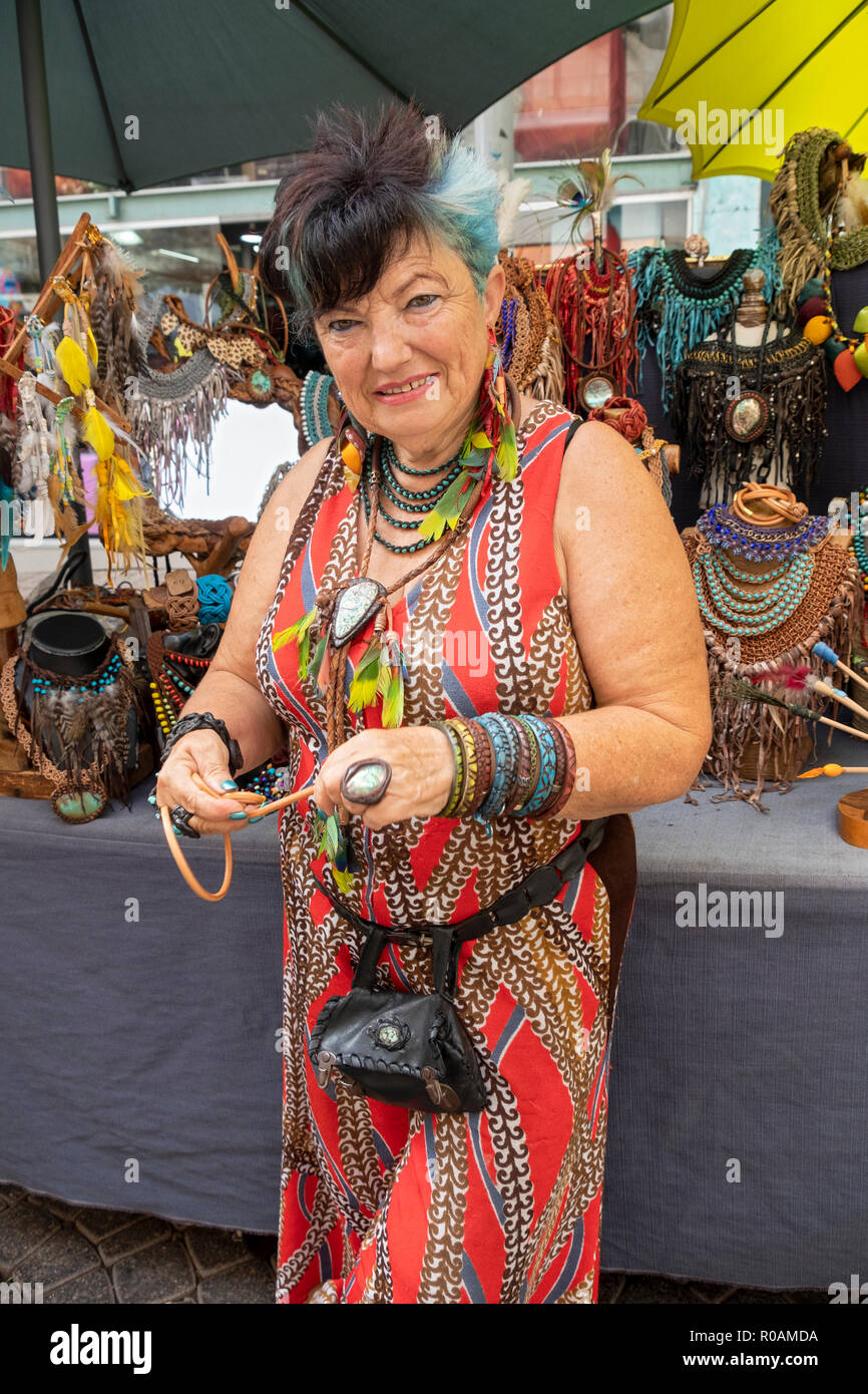 Posed portrait of an older Israeli woman with blue hair who sells leather jewelry at the Carmel Market in Tel Aviv, Israel. Stock Photo