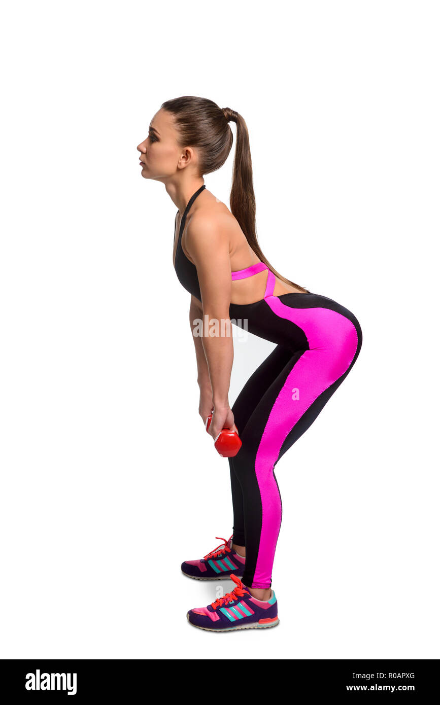 Athletic girl doing weighted squats Stock Photo