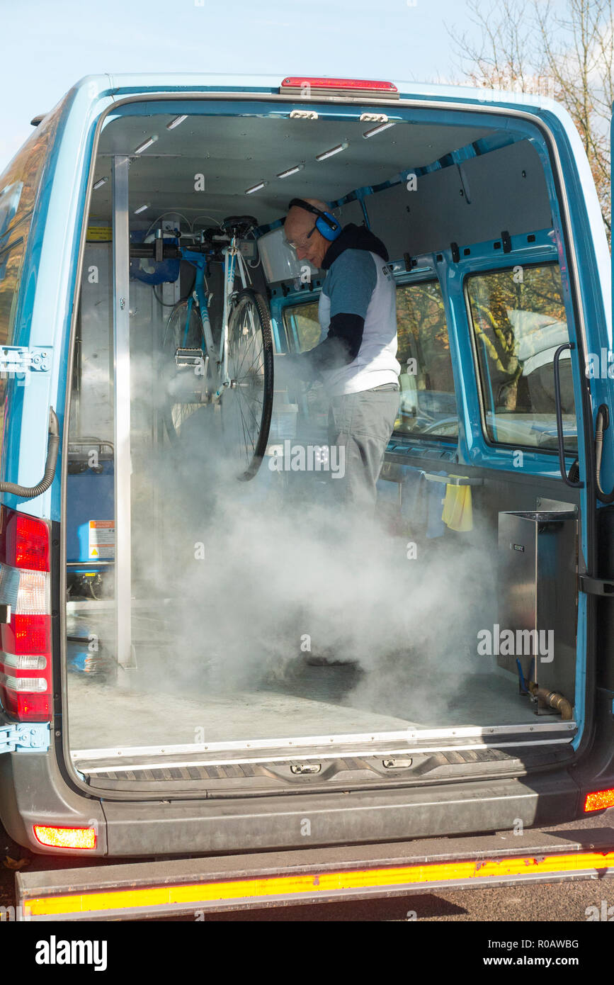 A bike / bicycle / cycle / bi cycle being cleaned under pressure at a