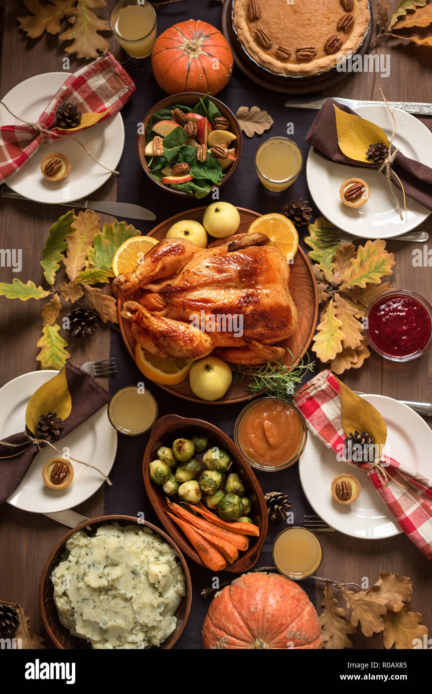 Thanksgiving Turkey Dinner with All the Sides. Homemade Roasted Turkey and all traditional dishes on Festive Thanksgiving table with autumnal decor. Stock Photo