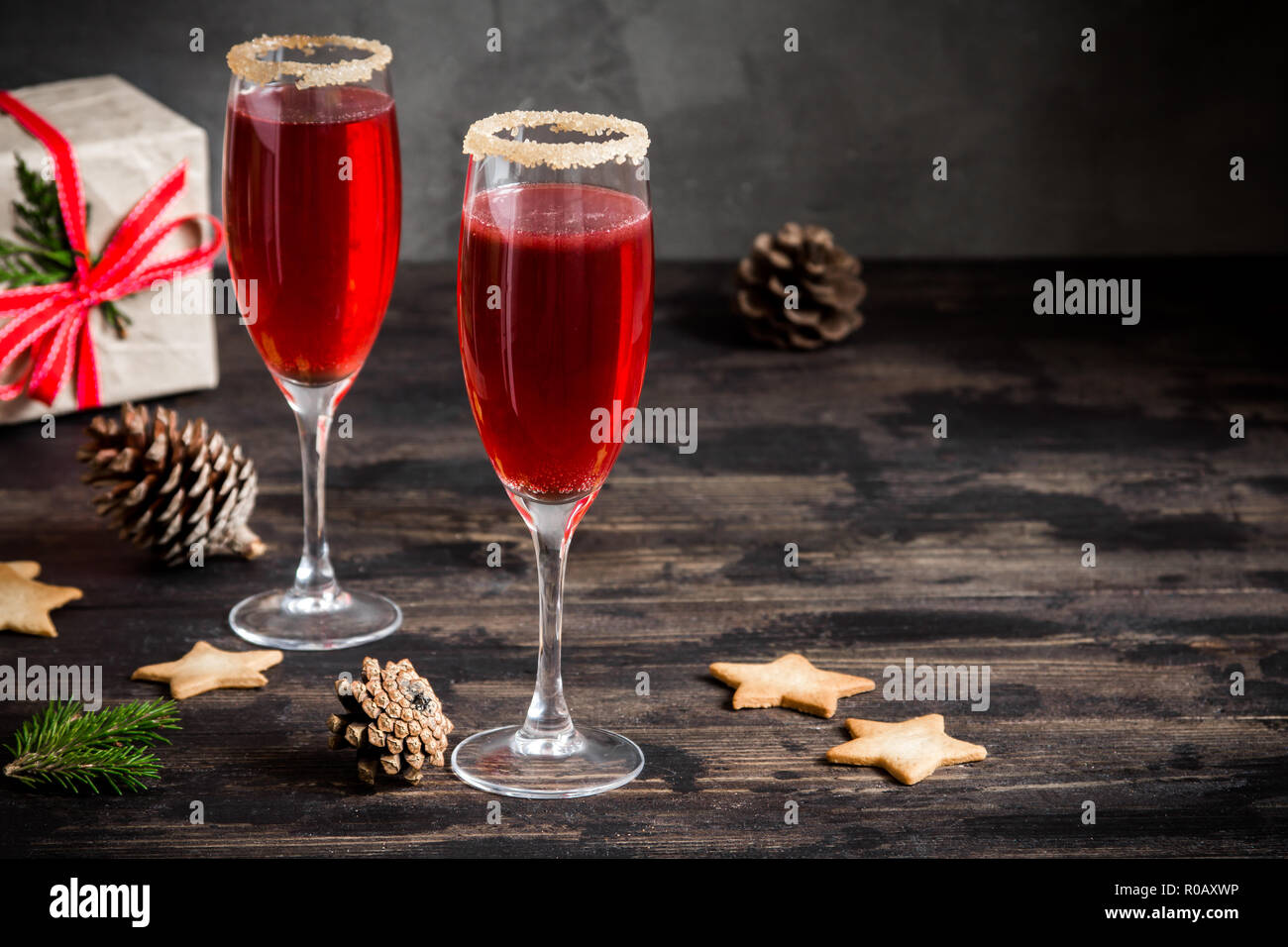 Mimosa festive drink for Christmas - champagne red cocktail Mimosa (mocktail) with cranberry for Christmas party, copy space Stock Photo