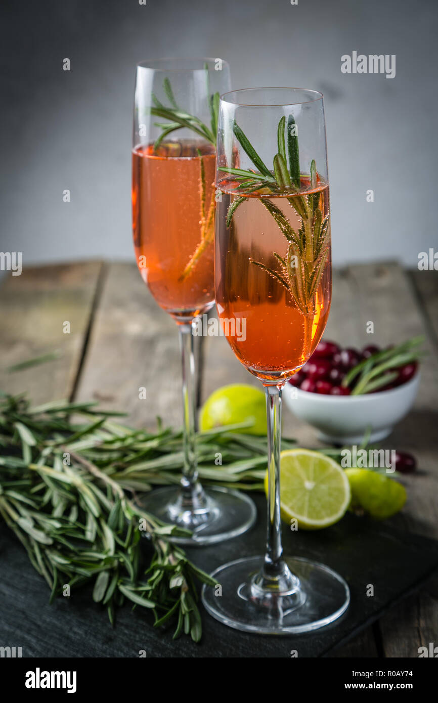Cranberry and rosemary champagne cocktail, rustic background Stock Photo