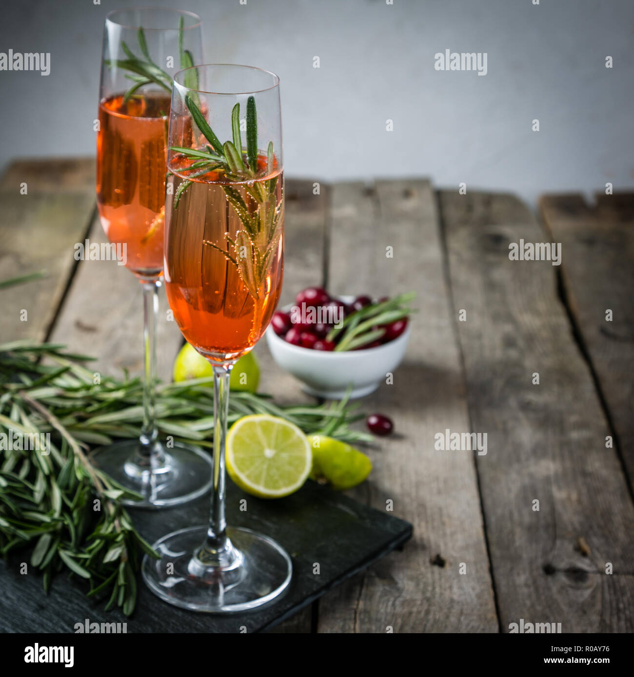 Cranberry and rosemary champagne cocktail, rustic background Stock Photo