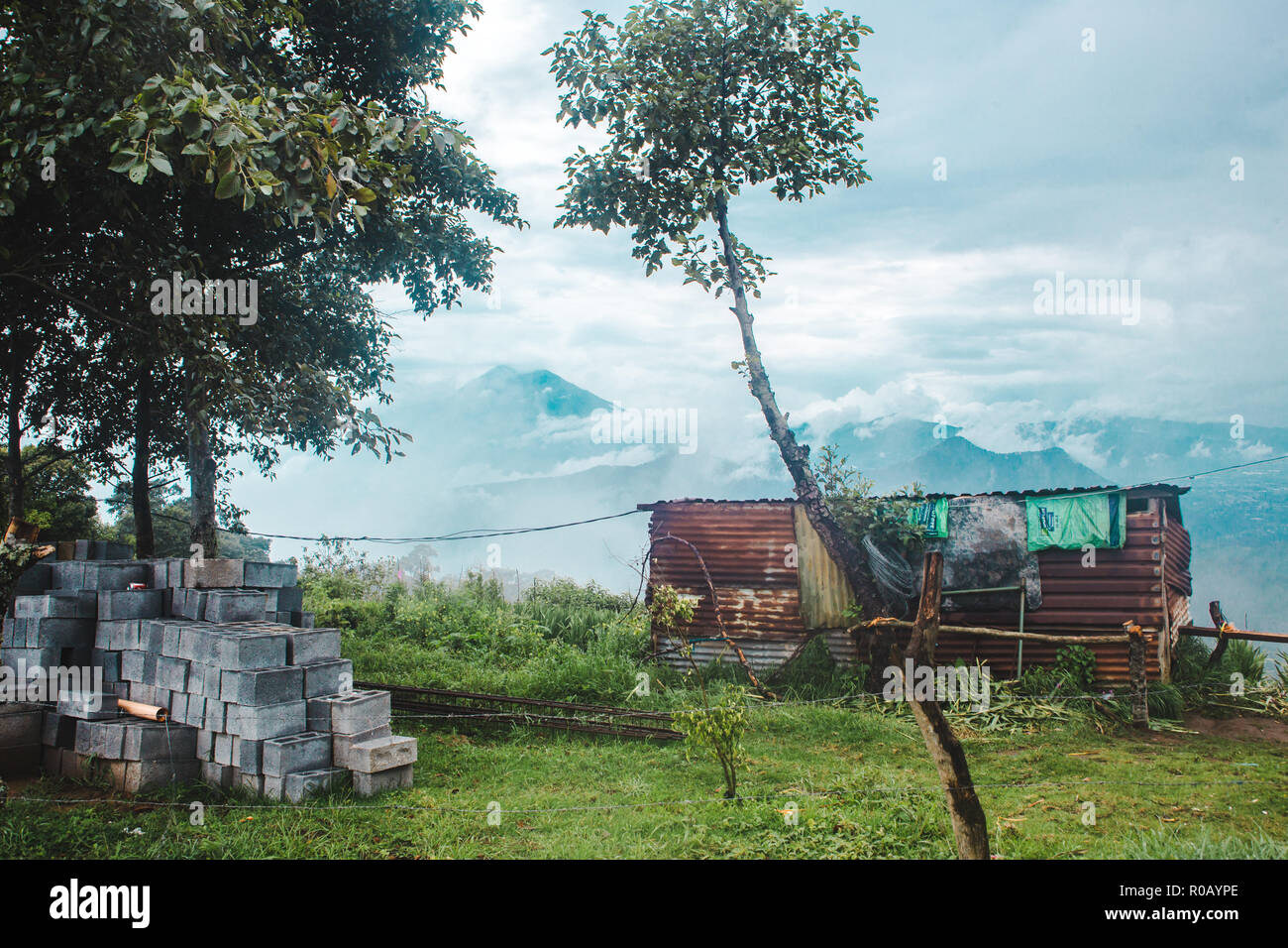 Small corrugated iron house in a grassy field with views over the green