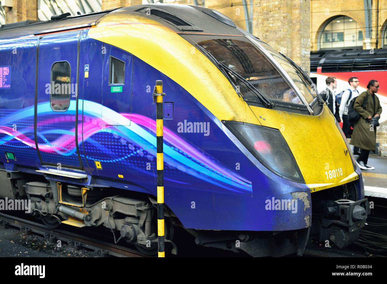 London, England, United Kingdom. A locomotive that lead a recent arrival at  London King's Cross Station idles as exiting passengers walk past. Stock Photo
