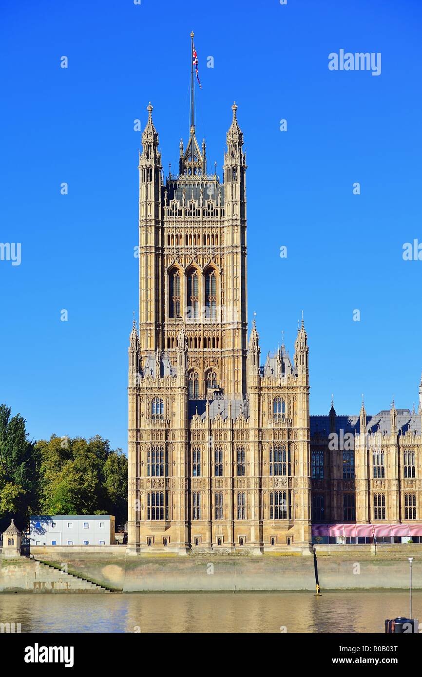London, England, United Kingdom. Victoria Tower and the Houses of Parliament beyond the River Thames. Stock Photo