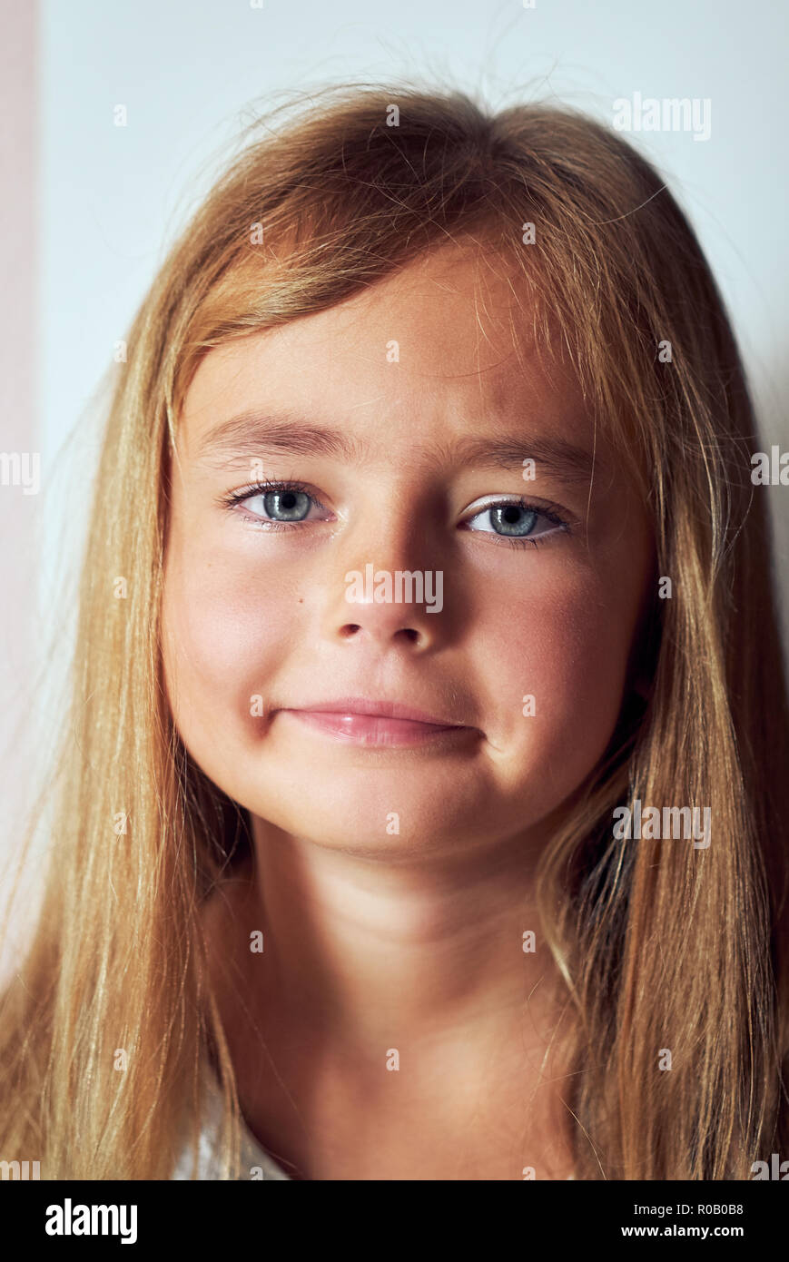 Portrait of adorable little six or seven years old girl feels unhappy
