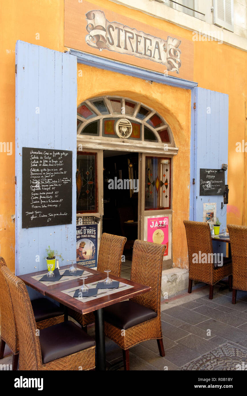 Empty tables outside an entrance to Restaurant A Strega, a street cafe in Le  Panier district, Marseille, France Stock Photo - Alamy