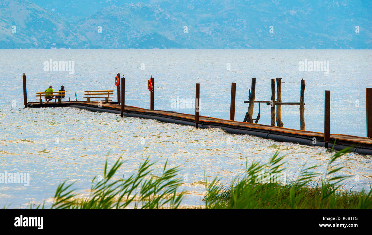 NORTHERN MACEDONIA. Couple enjoying the view across Lake Ohrid from a walkway. Stock Photo