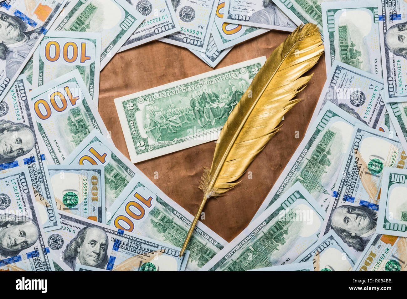 Two dollars depicting the signing of the declaration of independence on a bronze background in the form of a heart and a golden quill pen, surrounded  Stock Photo